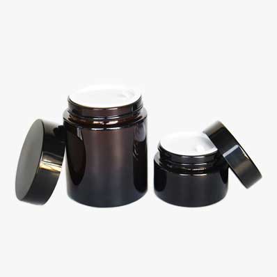 Wholesale 100ml amber glass cosmetic jars with black lids