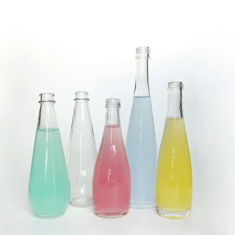 Factory price 750ml glass sparkling water bottle with caps wholesale