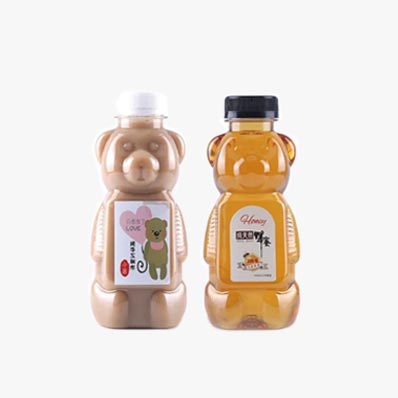 Wholesale custom size clear 250ml PET plastic bear juice bottles with caps