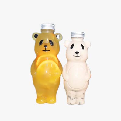 Bulk sale 700ml cartoon PET panada shape creative juice bottles with caps for juice/milk tea