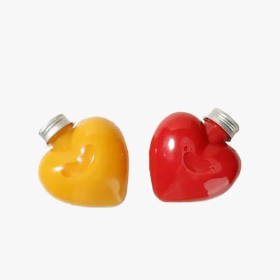 Unique design clear 300ml heart shaped PET twist off juice bottles with aluminum caps